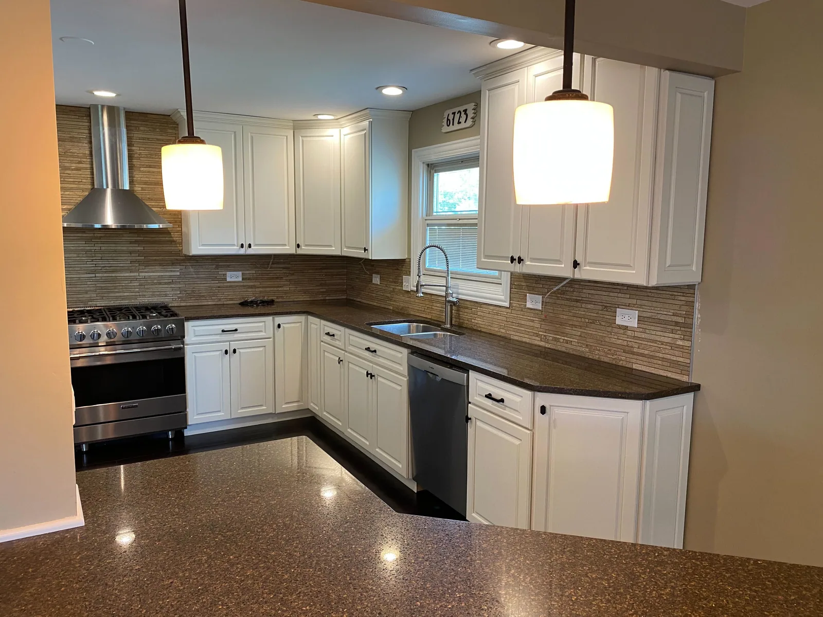 Refinished white kitchen cabinets with a tile backsplash