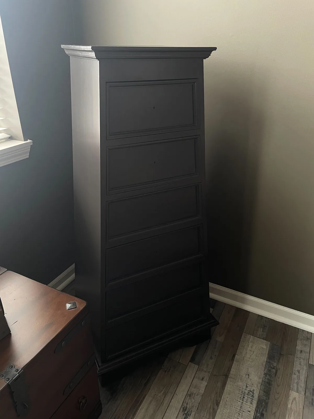 Refinished black cabinet against a gray wall