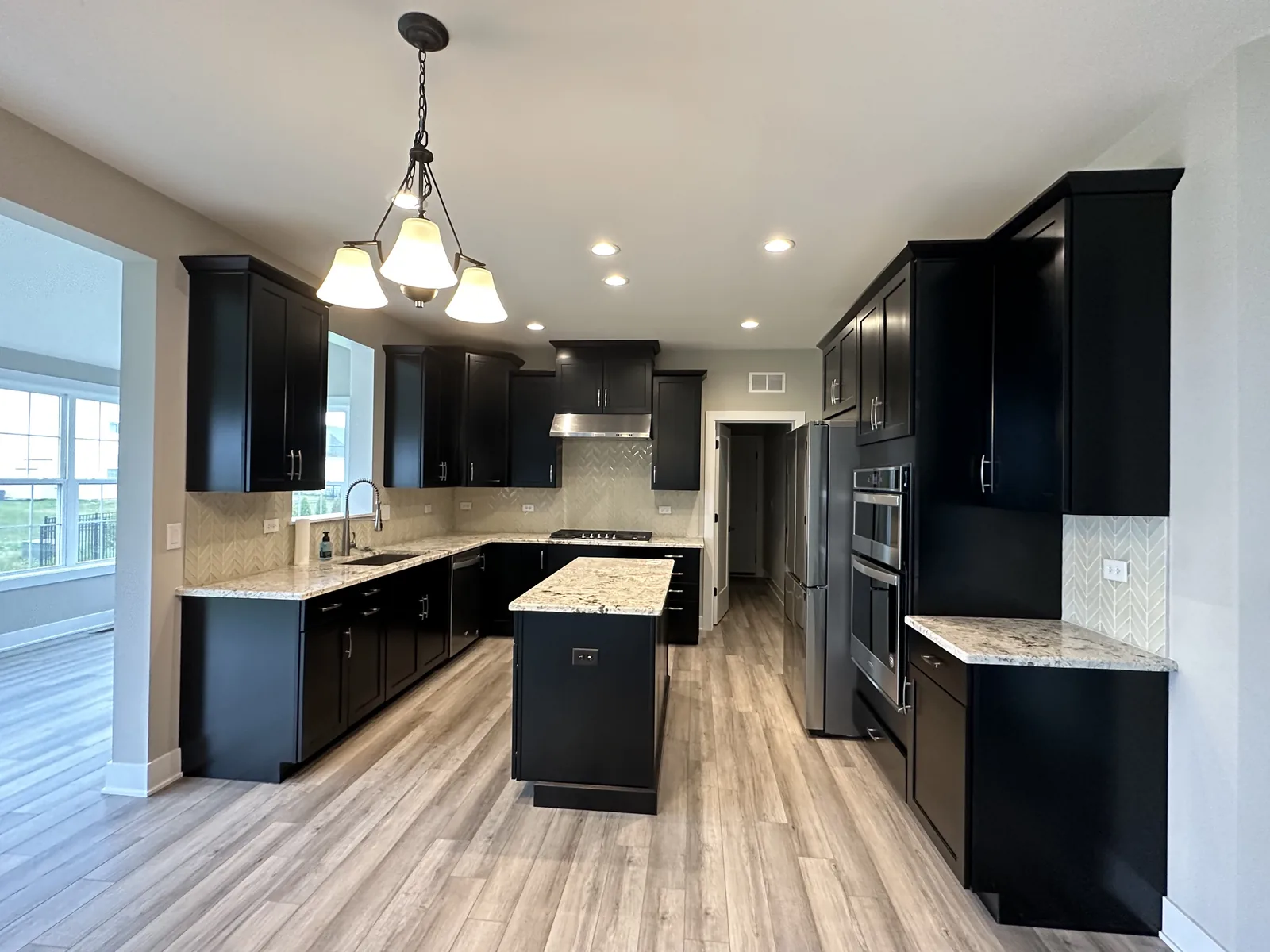 Kitchen cabinets refinished in black with a matching island