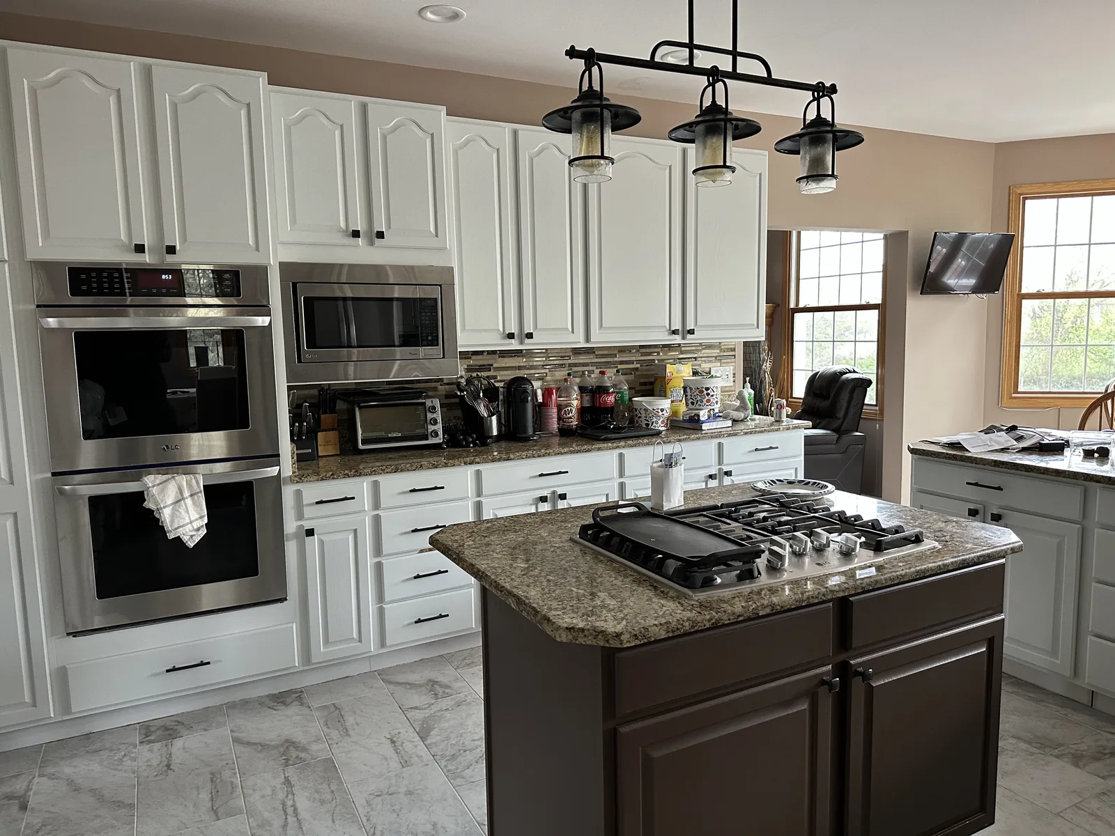 White refinished cabinets with a dark stained island