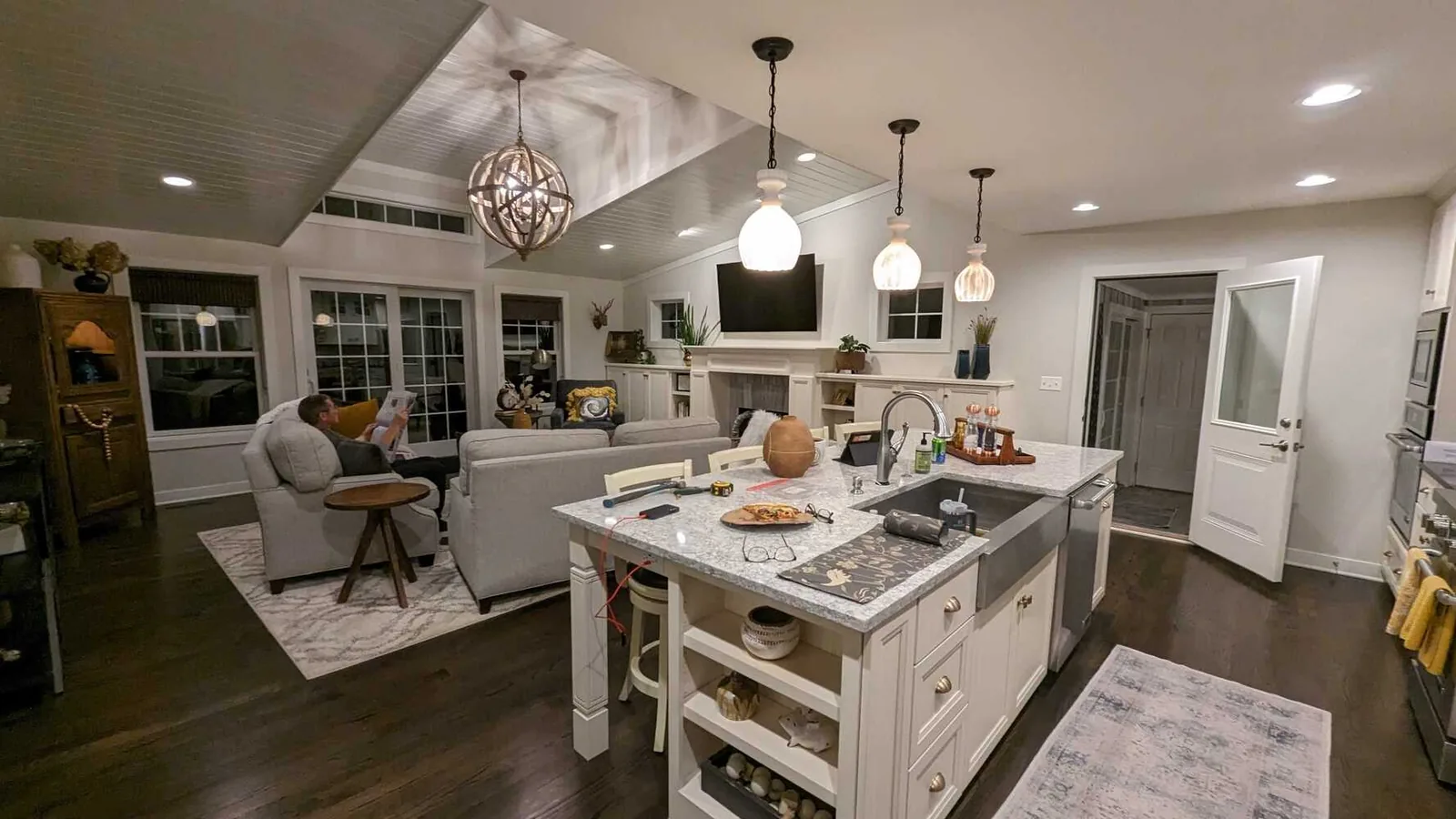 White refinished kitchen open to a family room
