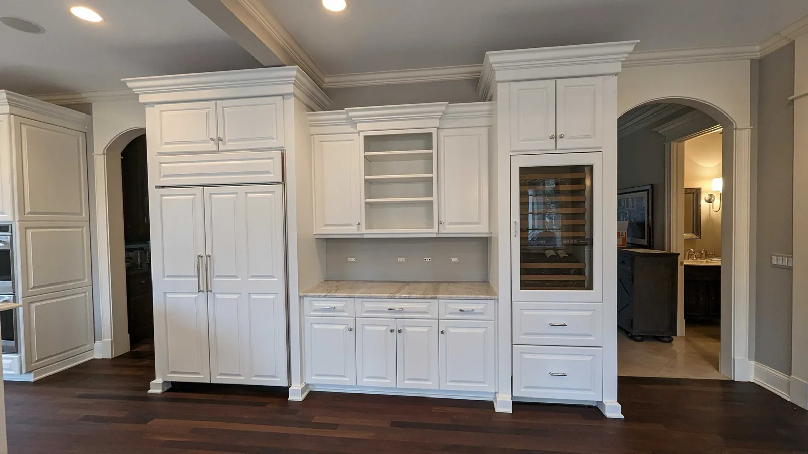 White built in cabinets refinished around a wine fridge