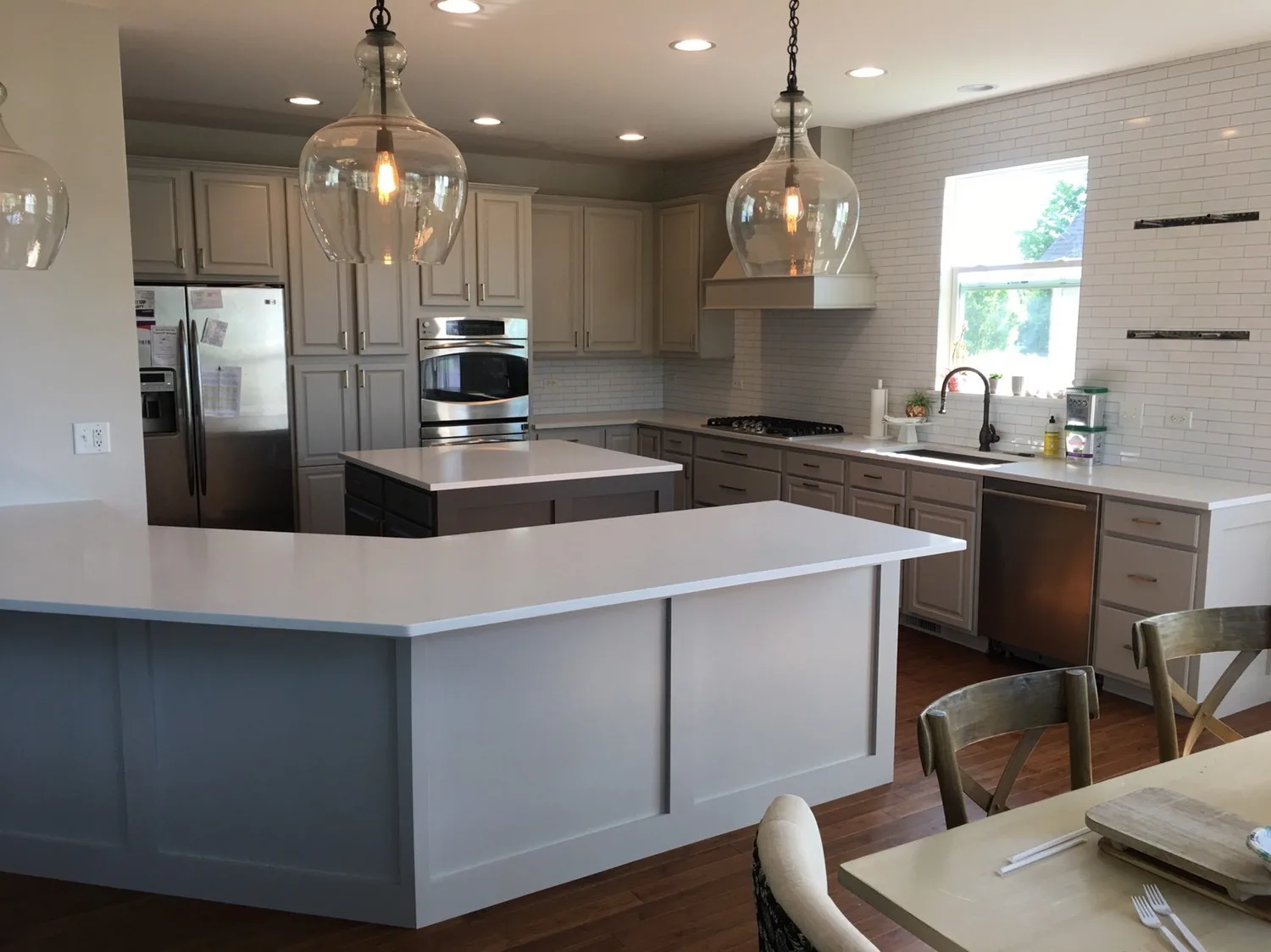 Gray refinished island with white perimeter cabinets