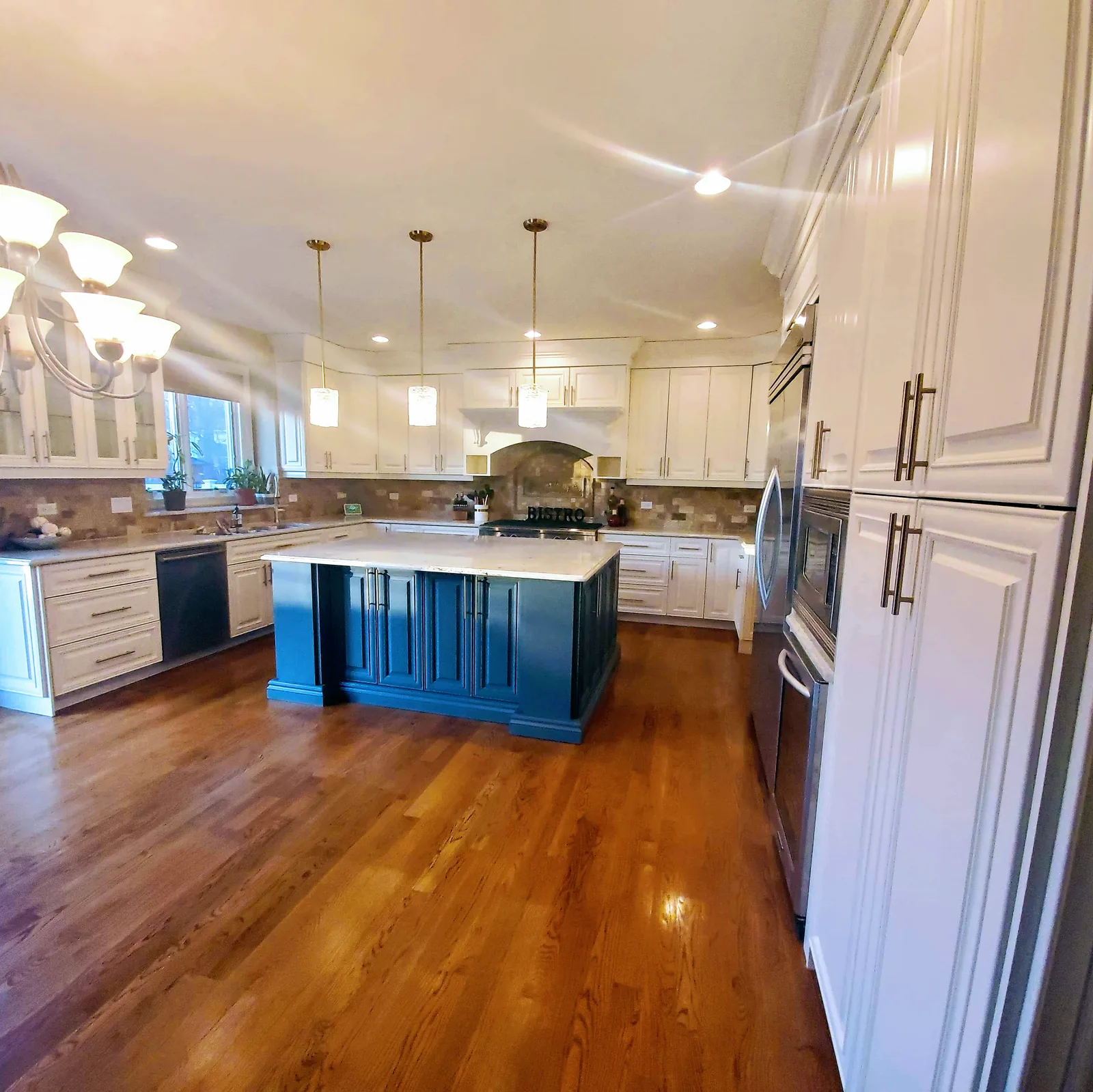 White refinished cabinets with a navy island