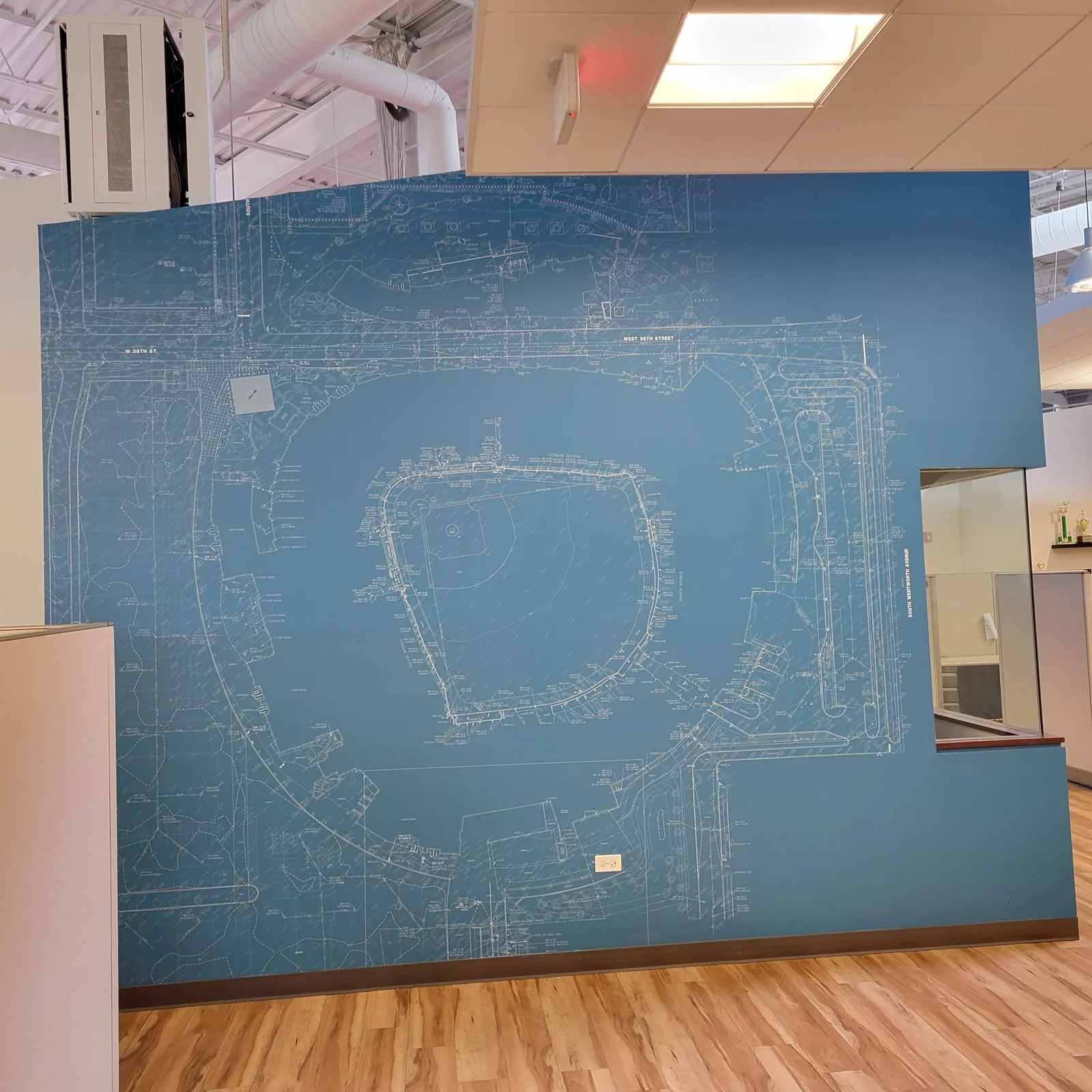 Blueprint stadium mural installed on an office wall