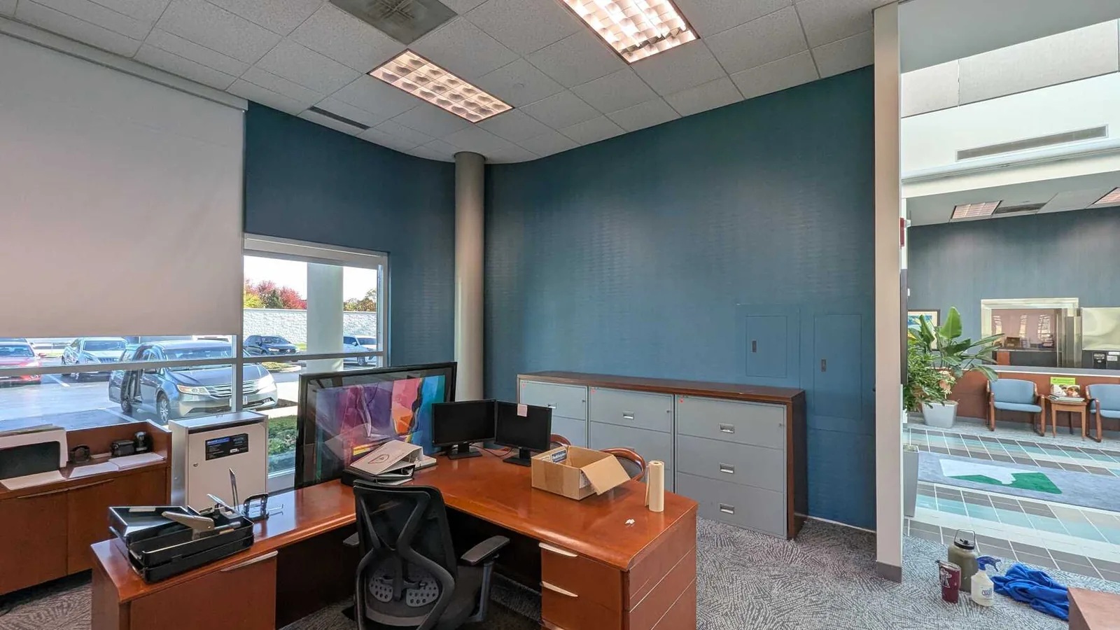 Office with a teal accent wall after a commercial repaint