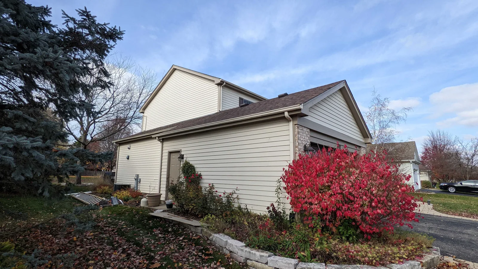 Repainted siding and trim on a suburban home in fall
