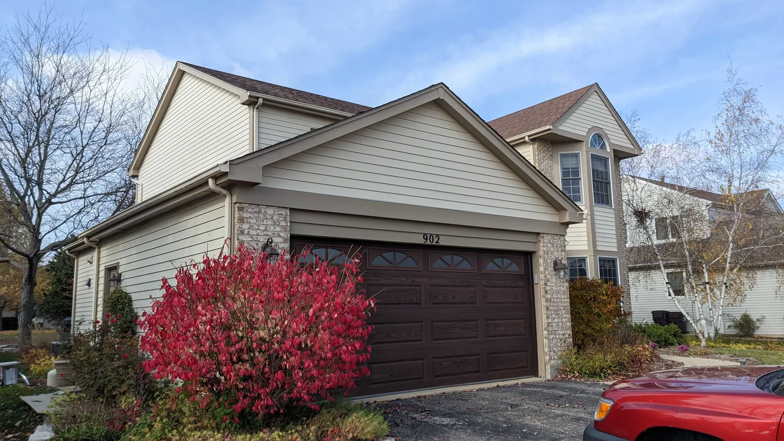 Repainted home with a dark brown garage door