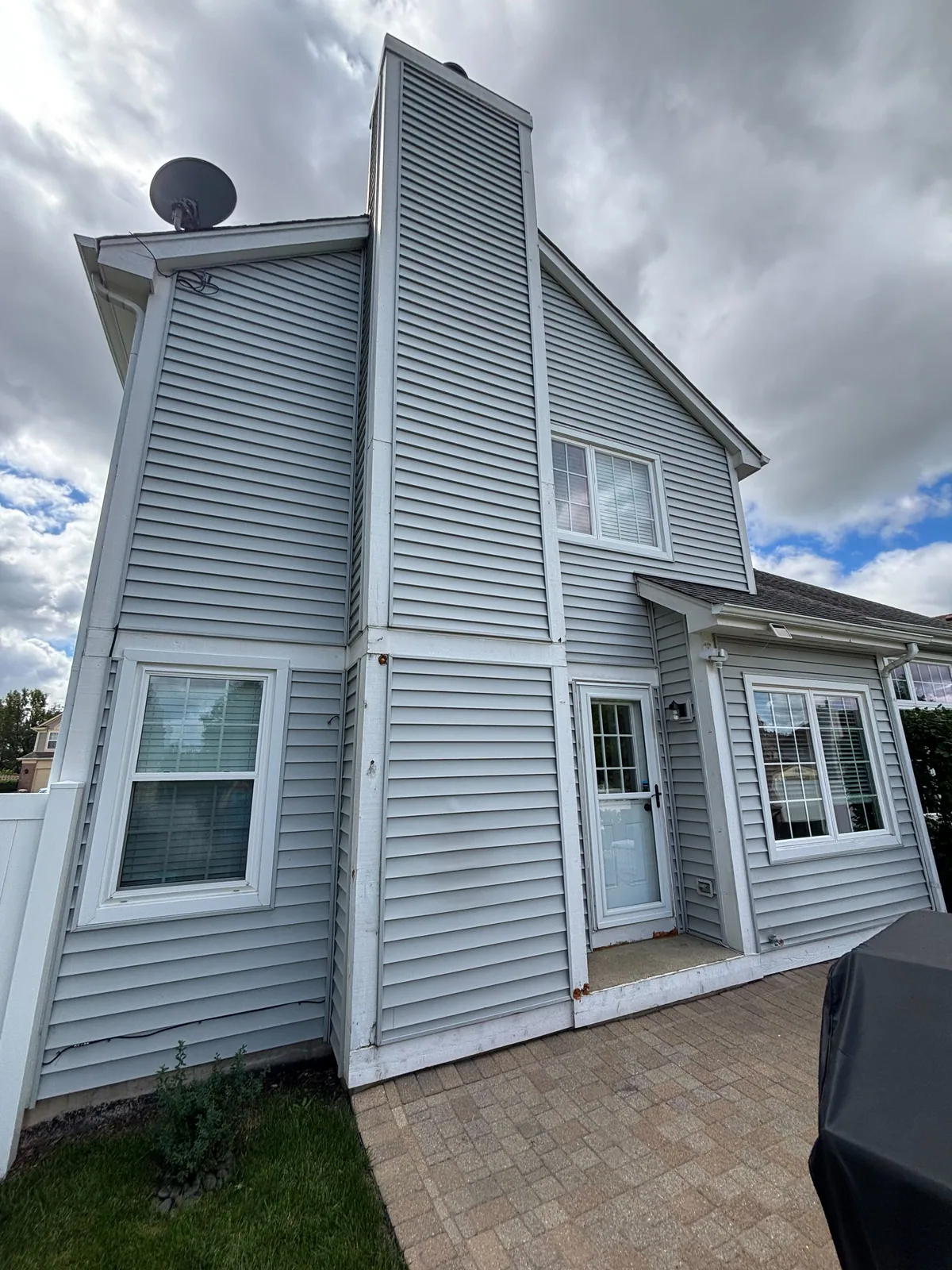 Light blue siding and white trim after an exterior repaint