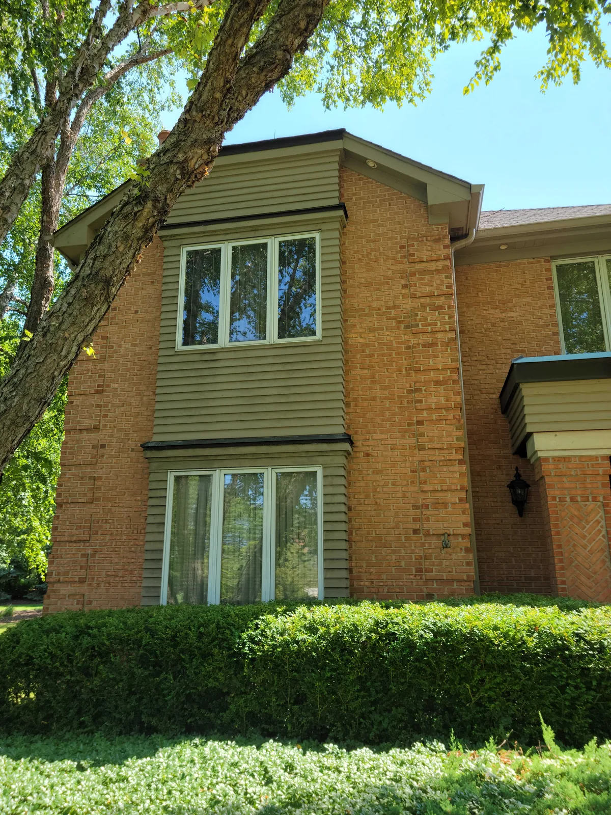 Brick and siding repaint with olive window trim