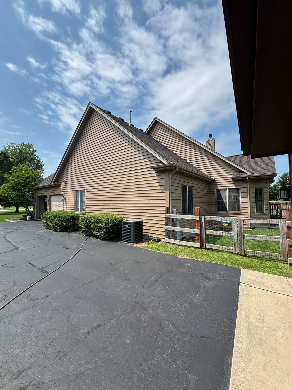 Repainted siding and trim beside a driveway