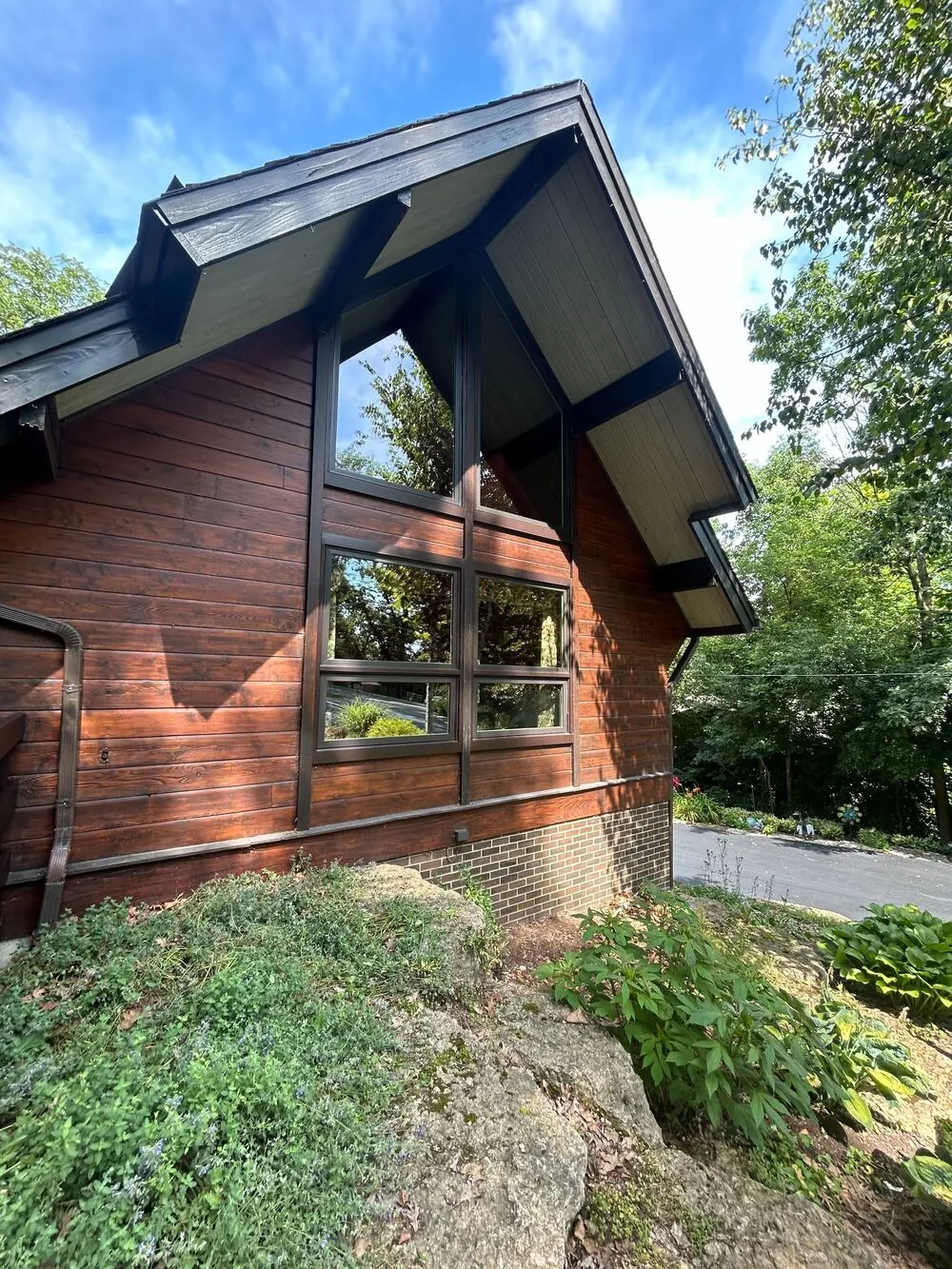 Restained cedar siding and dark trim on a modern home