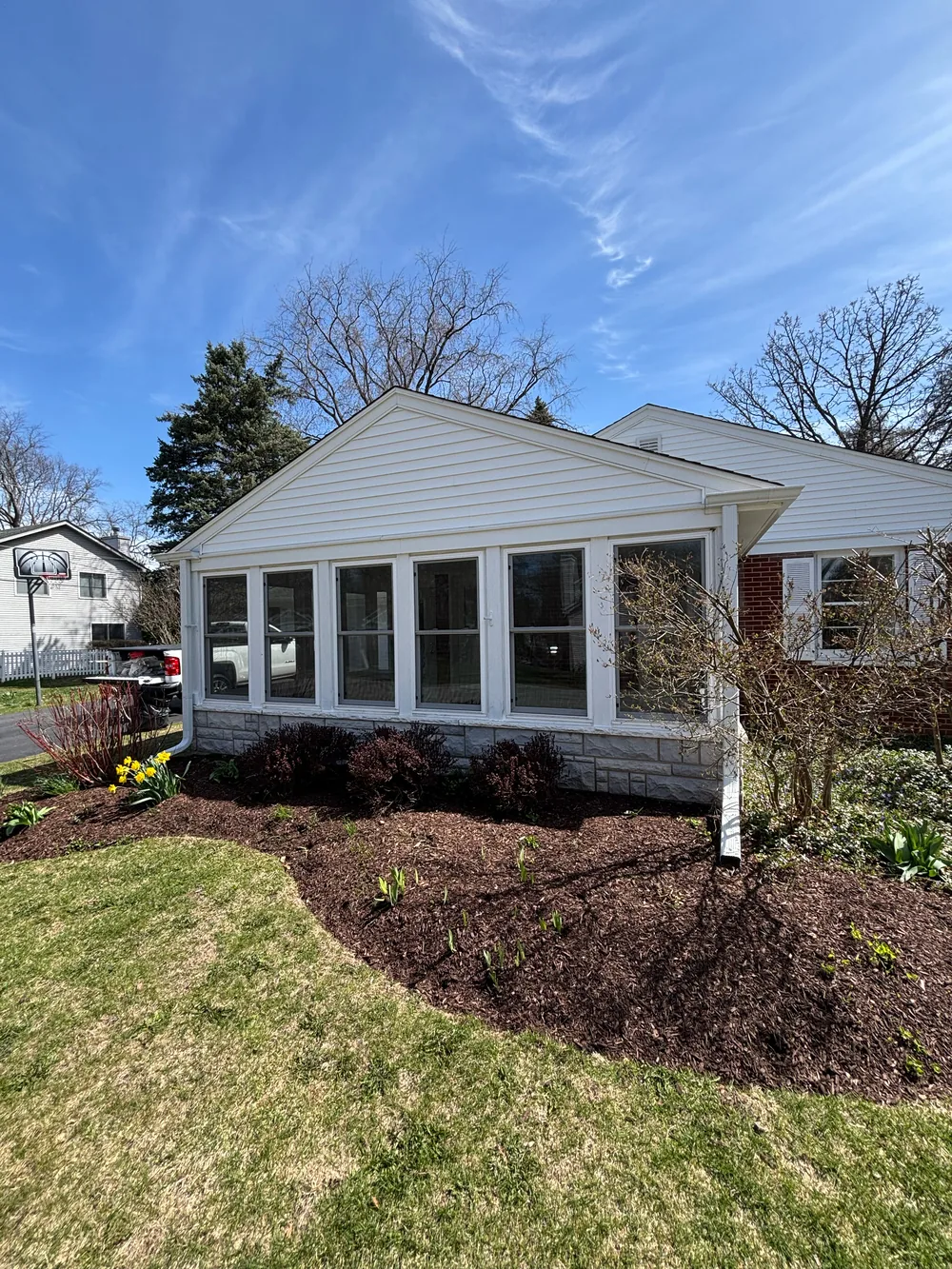Repainted sunroom addition with white trim
