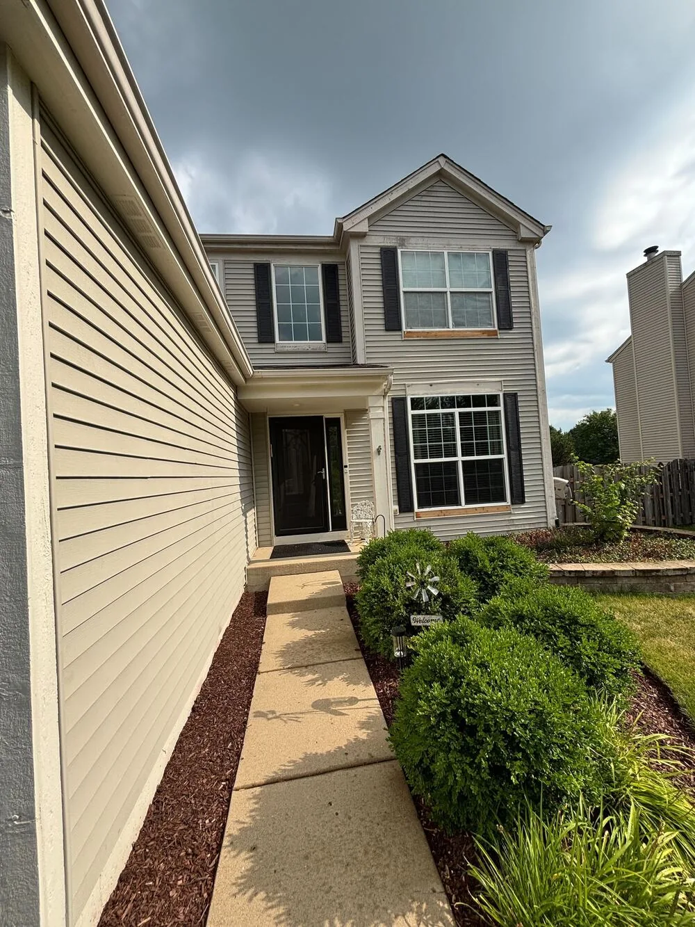Repainted siding along a side yard walk