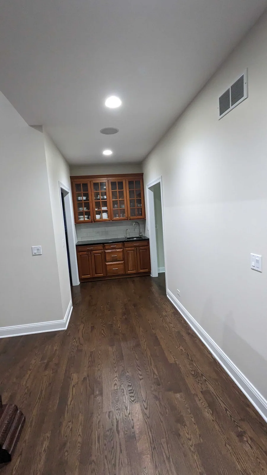 Freshly painted hallway leading into a kitchen