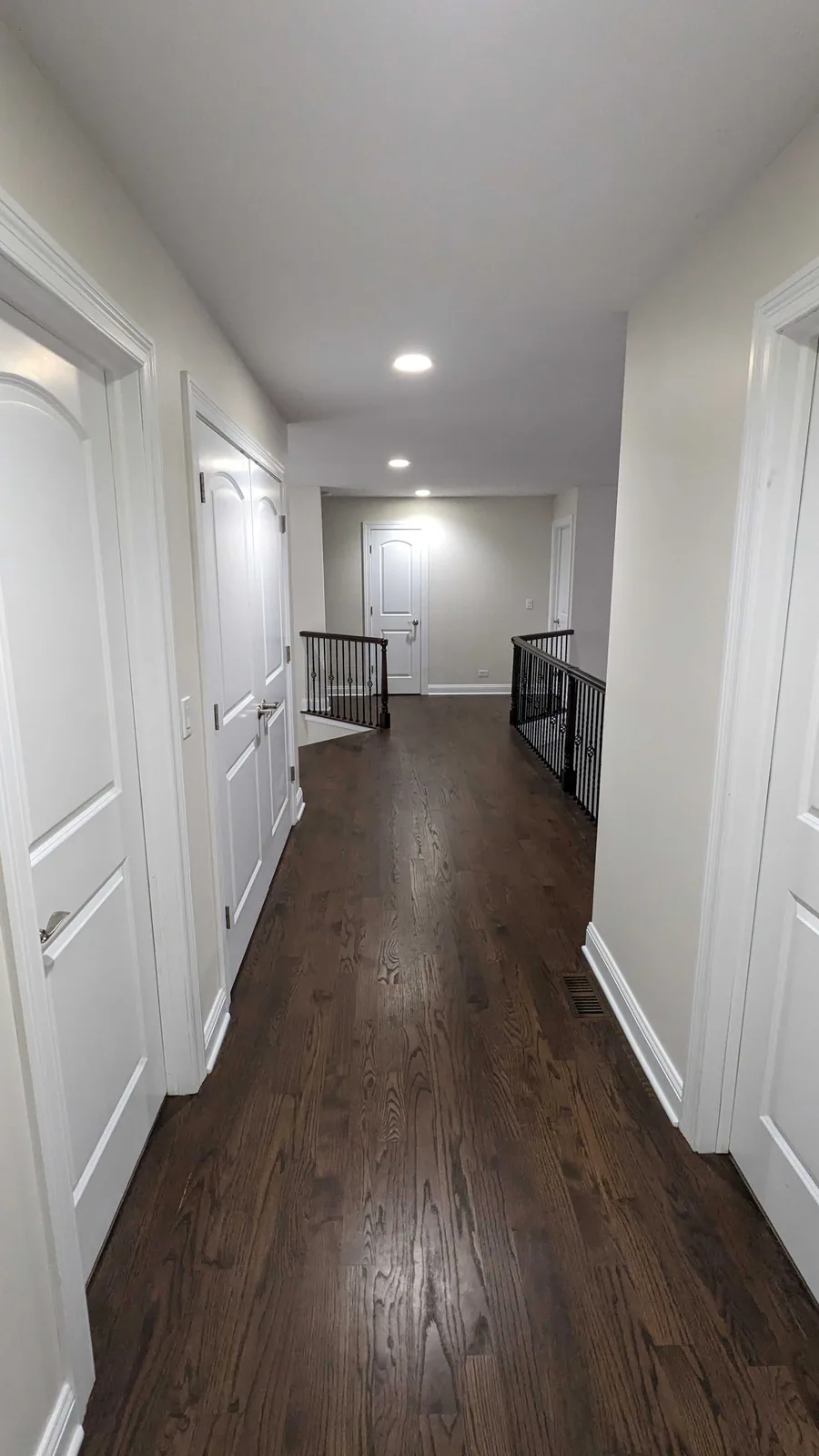 Repainted upstairs hallway with white trim and doors