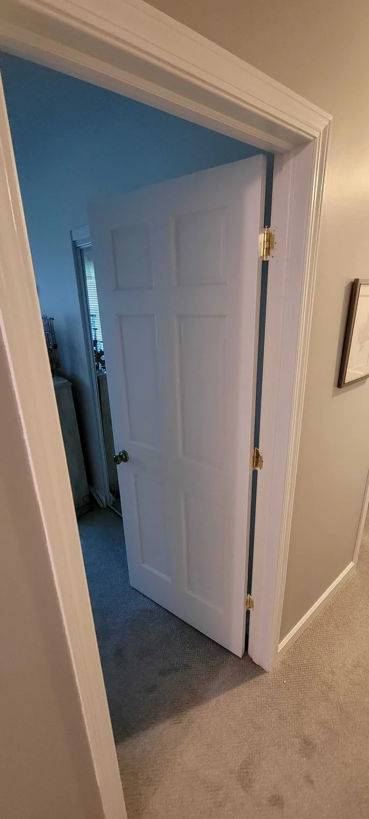 Bedroom doorway with a blue accent wall