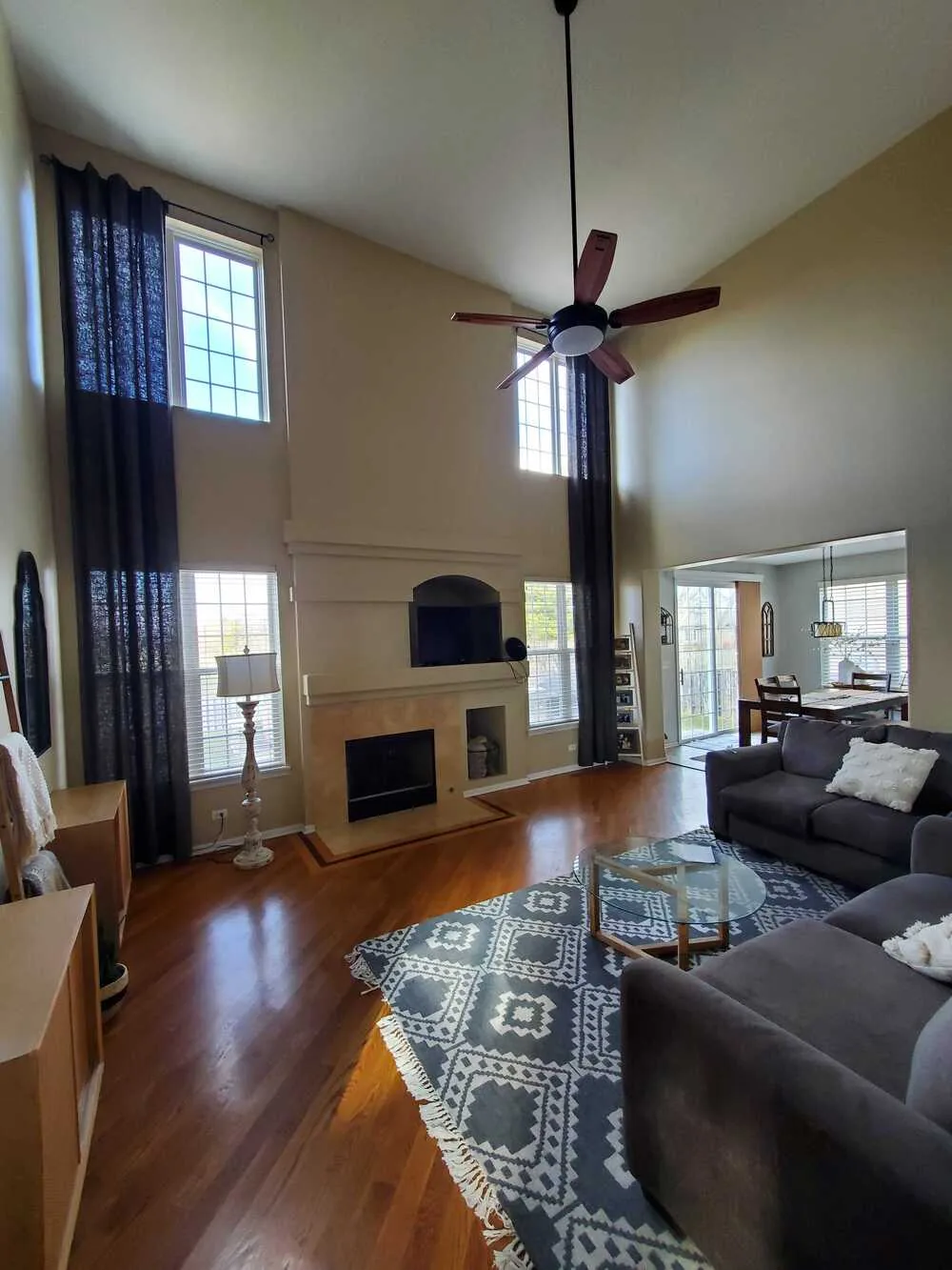 Two story family room repainted in a warm neutral
