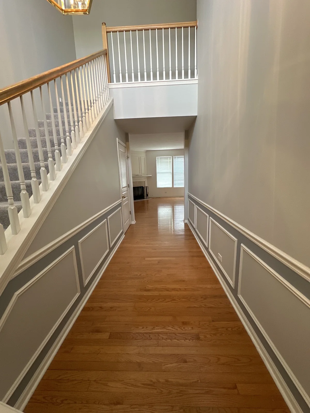 Hallway with gray walls and white wainscoting