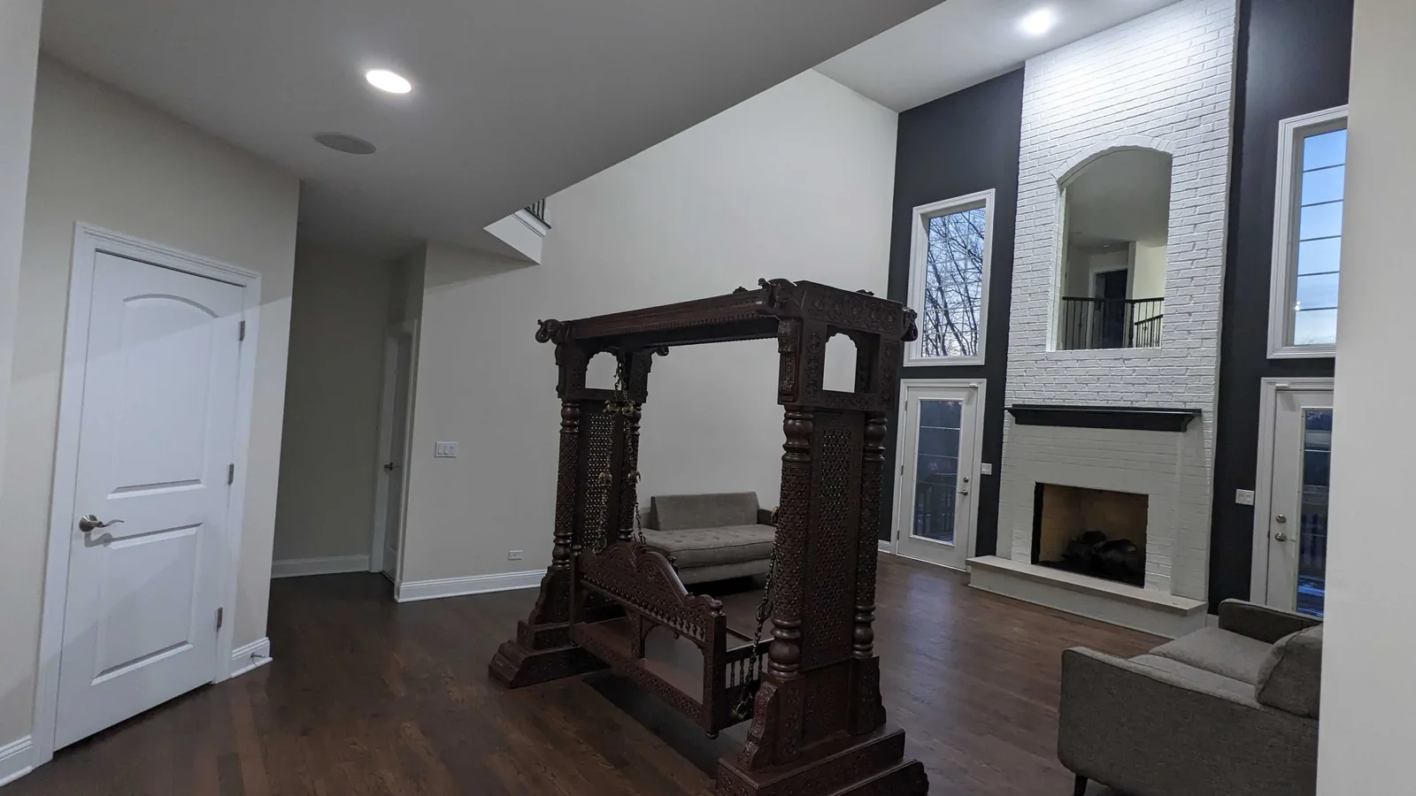 Great room with a black painted fireplace wall