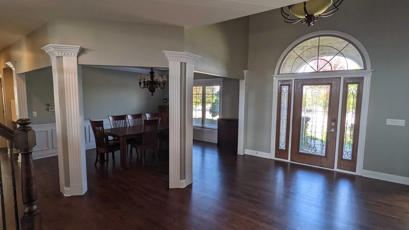 Entry with white columns and a repainted dining room