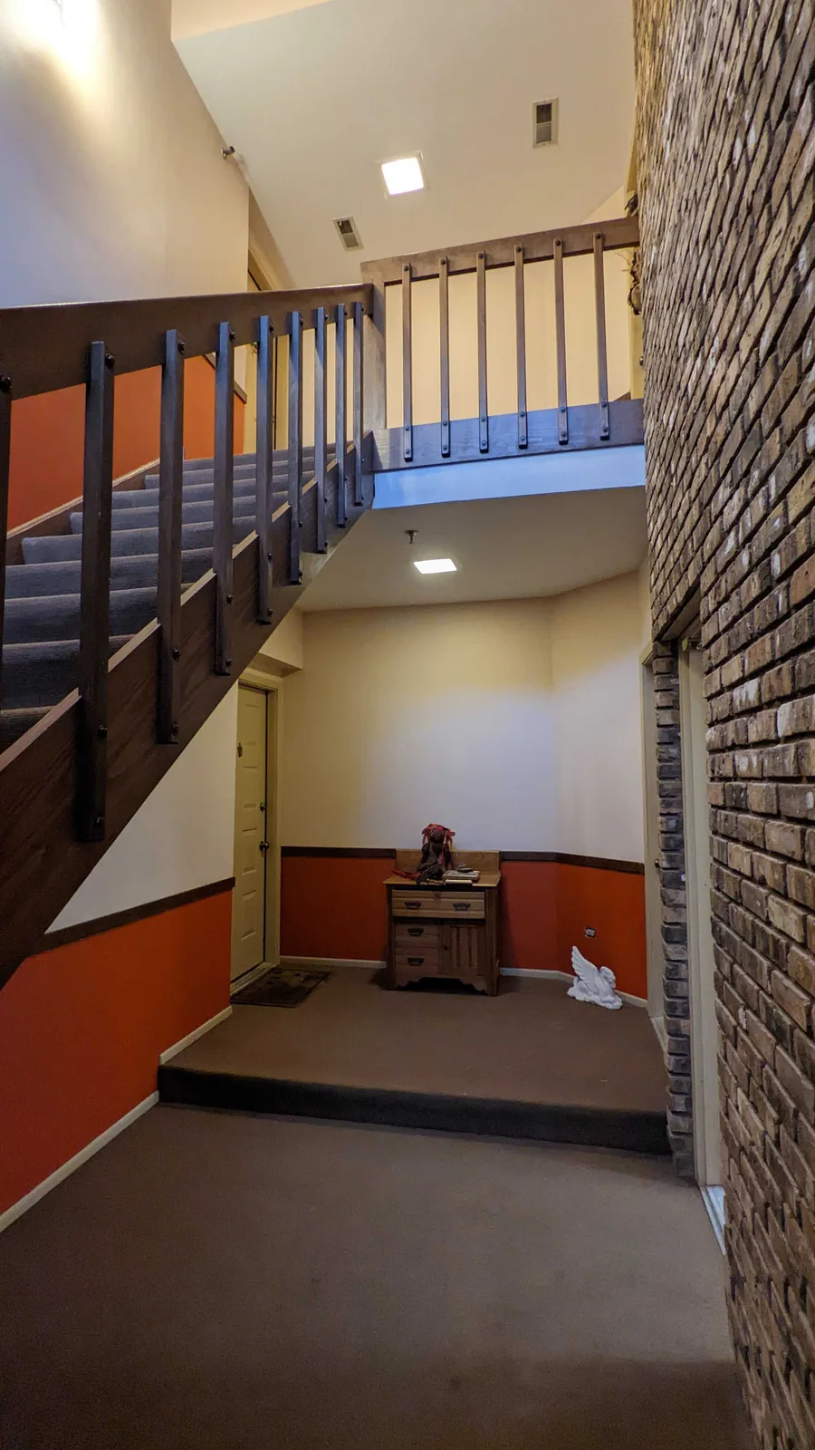 Two story stairwell repainted after wallpaper removal
