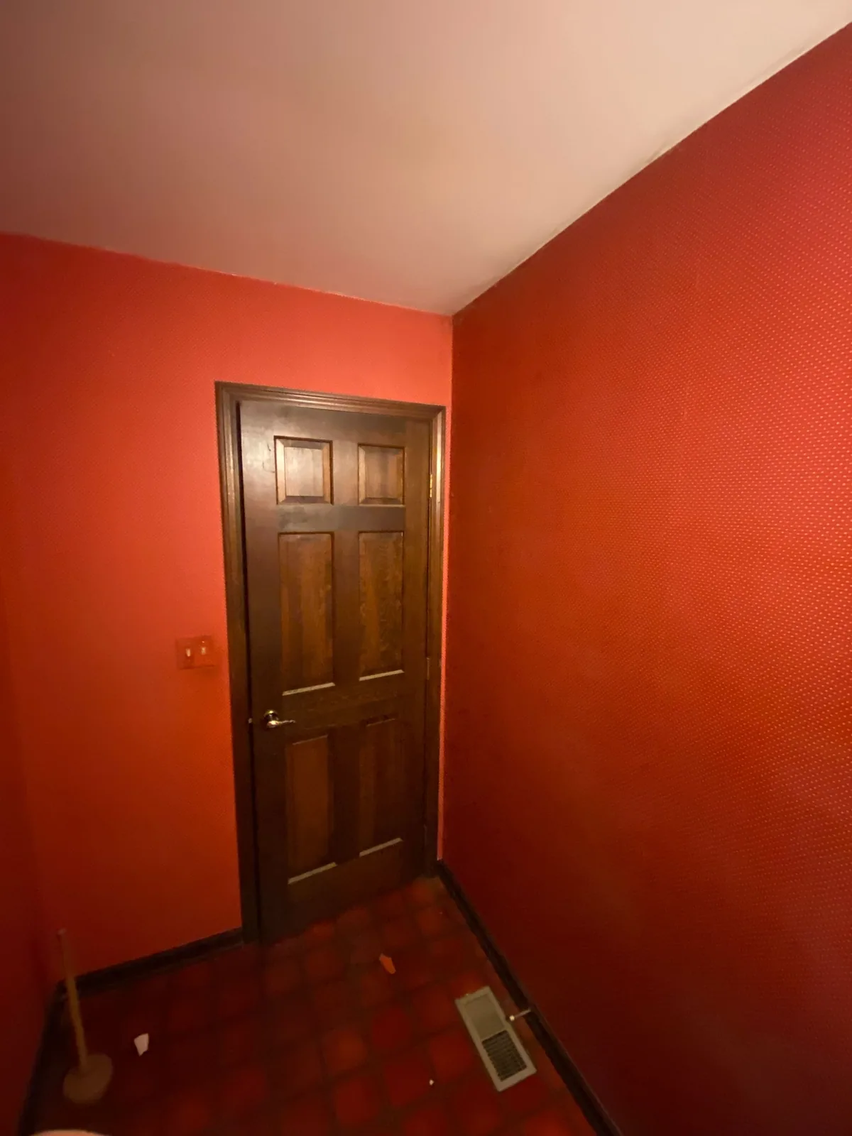 Wall repainted red after wallpaper removal
