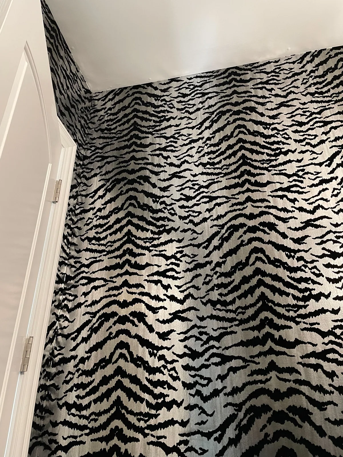 Black and silver animal print wallpaper in a stairwell