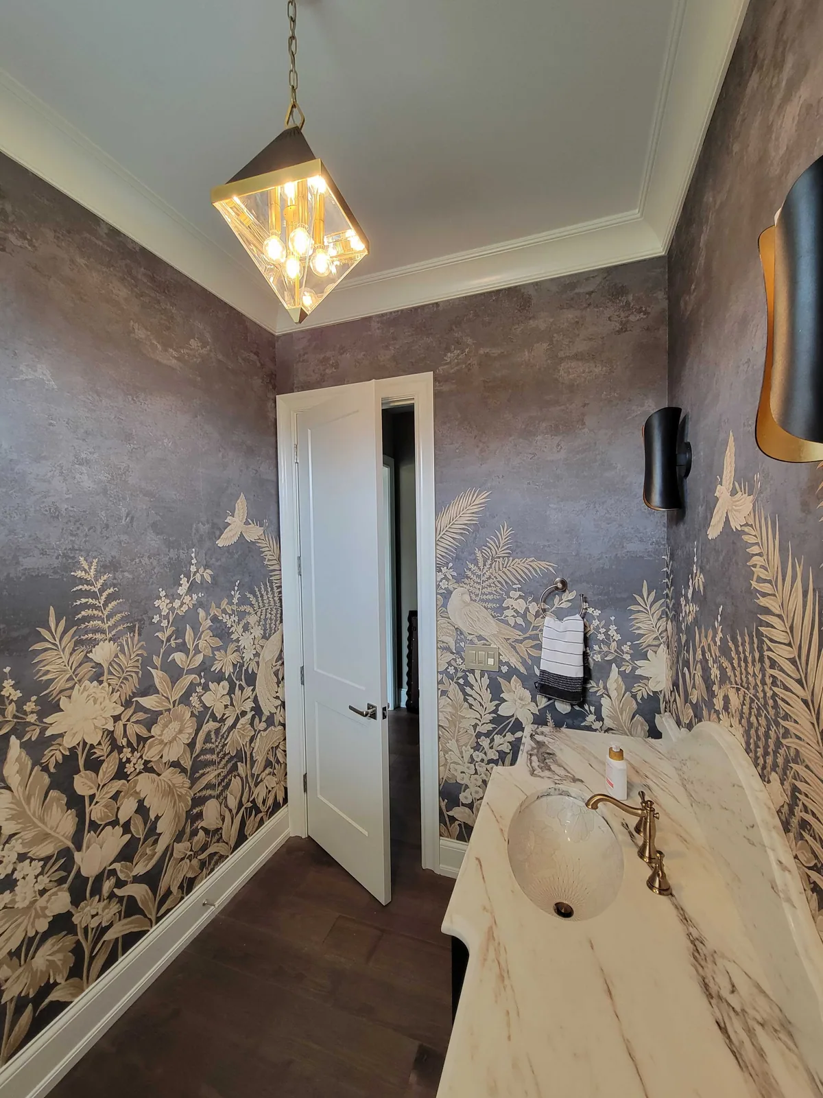 Navy and gold mural wallpaper in a powder room