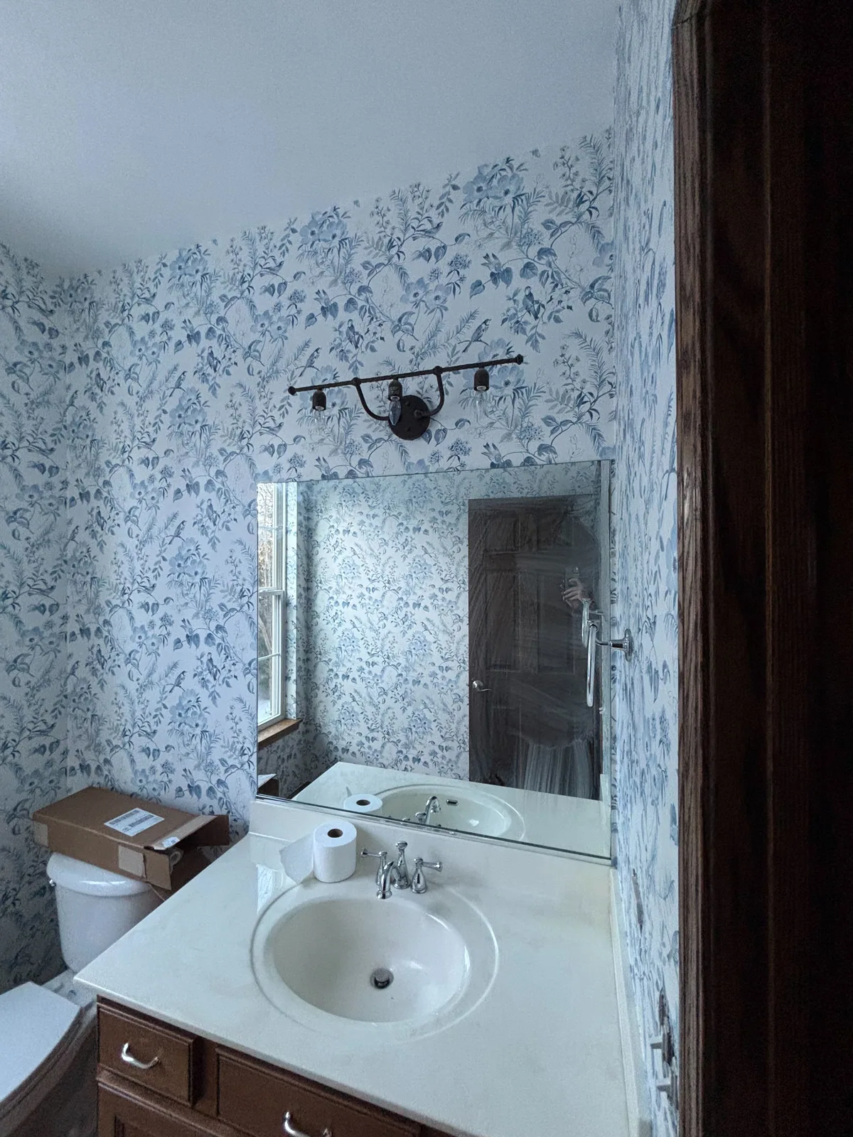 Blue floral wallpaper in a bathroom