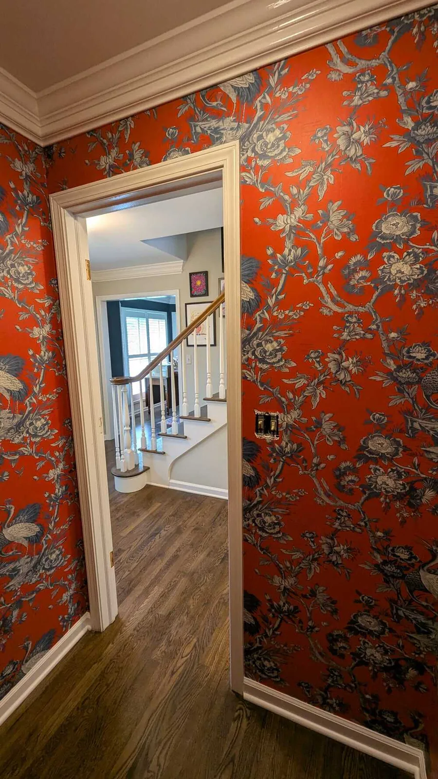 Red floral wallpaper in an entry hall