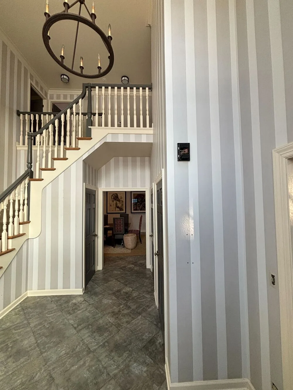 Gray striped wallpaper in a two story foyer