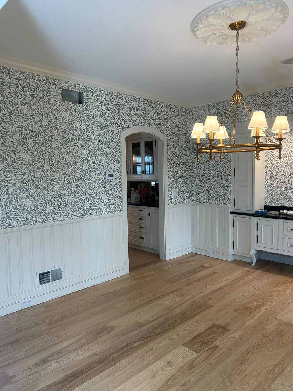 Blue botanical wallpaper in a dining room