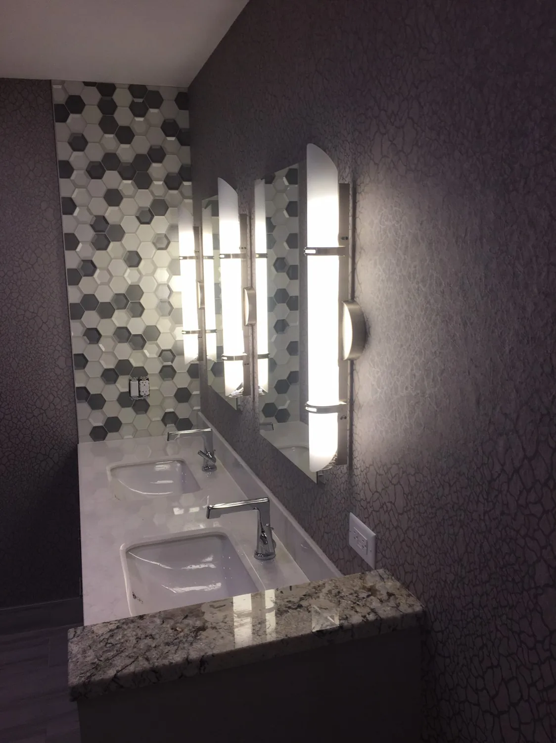 Hexagon wallpaper in a bathroom with a double vanity