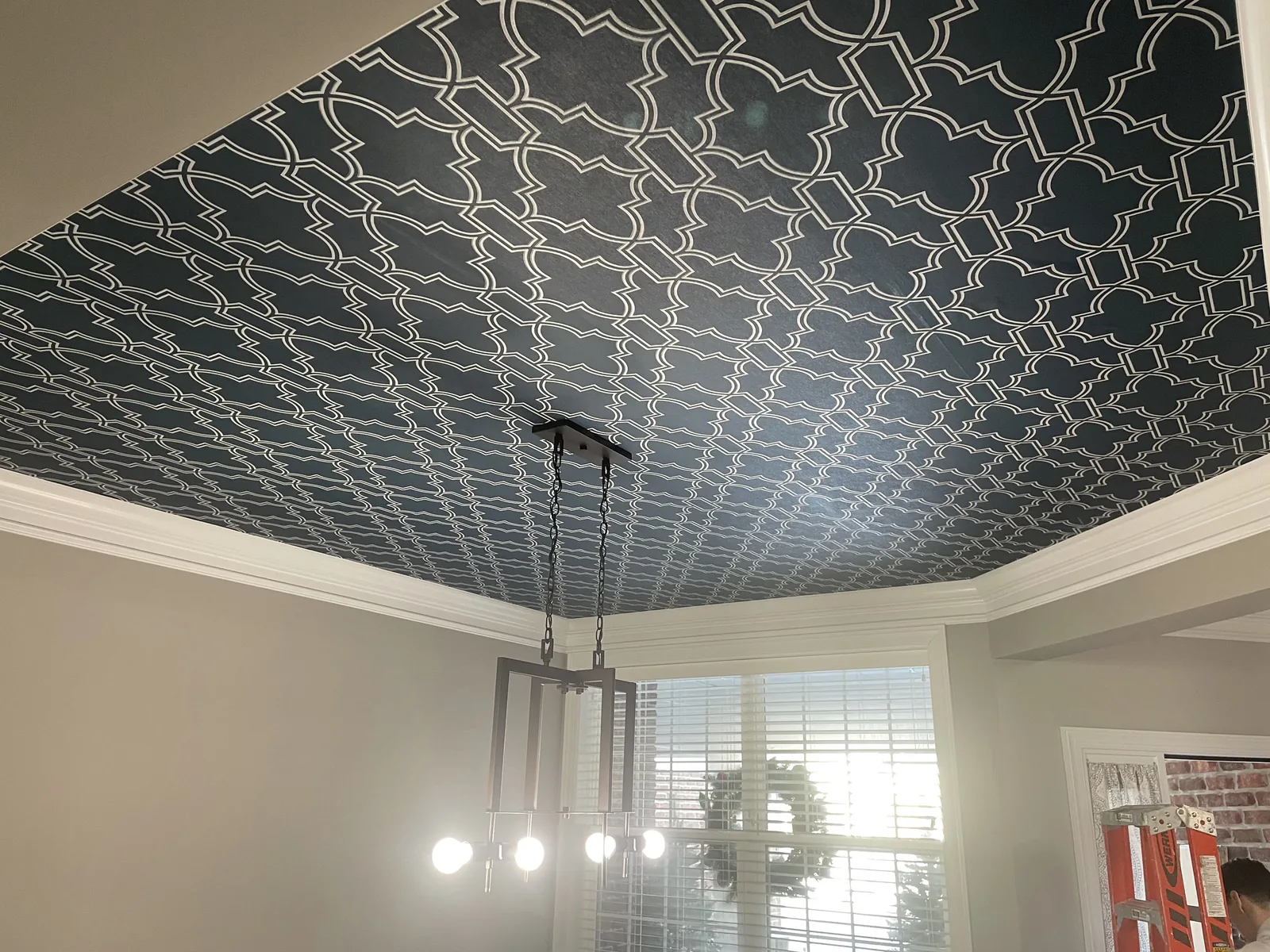 Navy trellis wallpaper on a dining room ceiling